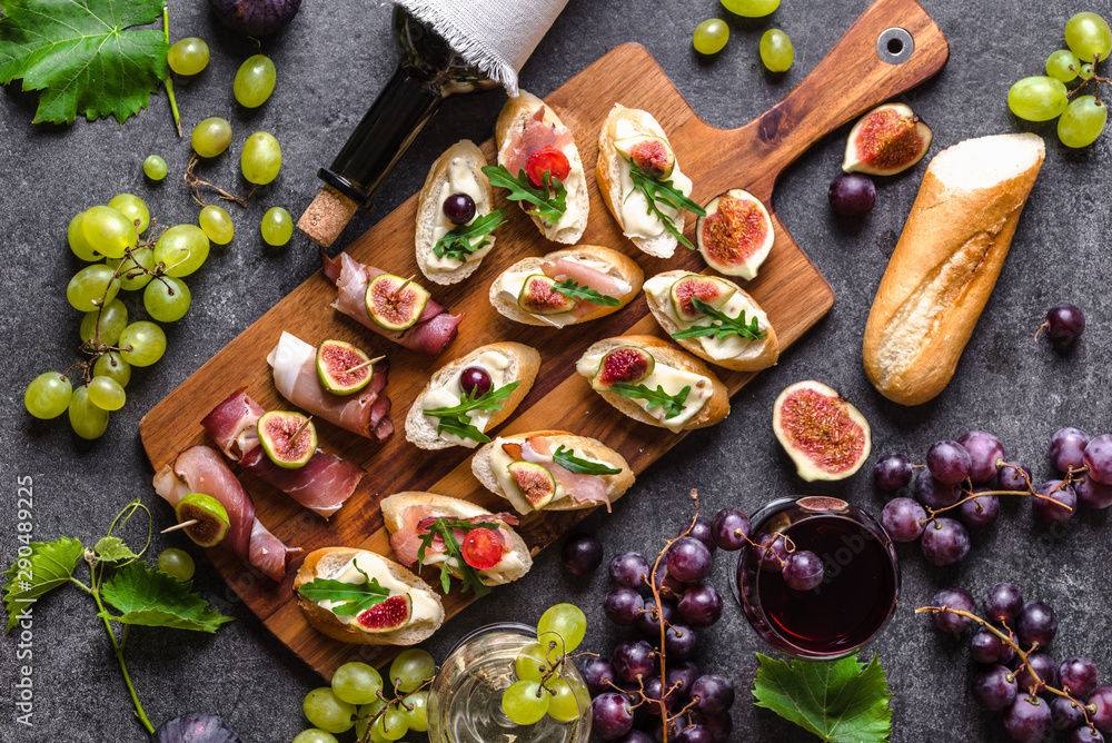 Traditional tapas bar, spanish table with food, platter with appetizers or  italian bruschetta with cheese and meat. Wine snack set Stock Photo | Adobe  Stock