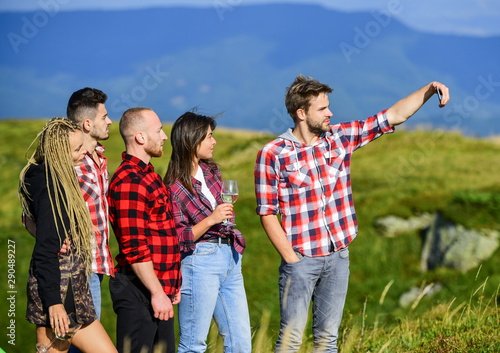 Capturing memories. Men and women posing for family photo. Group friends taking selfie. Send selfie social networks. Selfie time concept. People in nature taking happy selfie landscape background