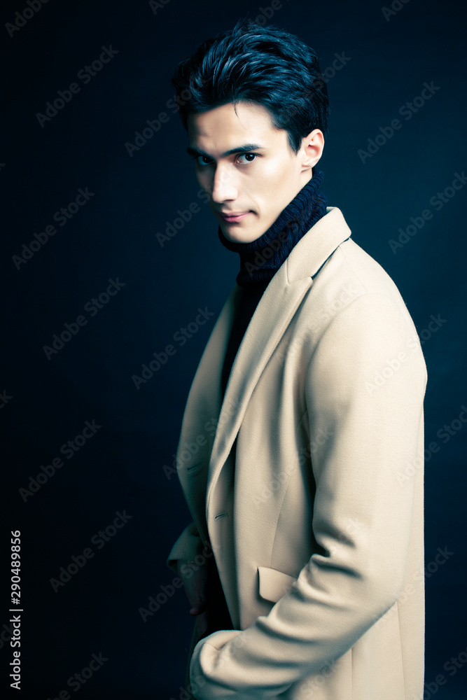 cool real young man in coat on black background posing, lifestyle people concept cool real young man in coat on black background posing, lifestyle people concept