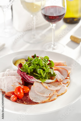 Gourmet  restaurant  delicious dinner food - close up of Sliced Meats with Rocket Salad and Tomatoes