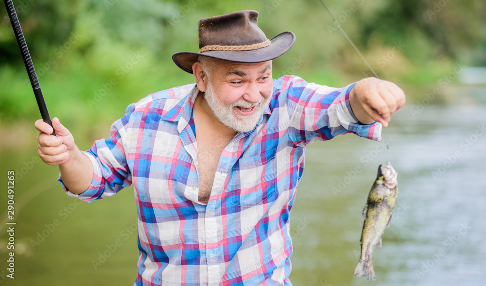 Slightly Older. pothunter. man catching fish. retired bearded fisher. big  game fishing. mature man fishing. sport activity and hobby. Trout bait.  summer weekend. fisherman with fishing rod Photos