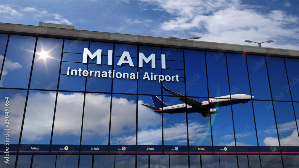 Obraz premium Airplane landing at Miami, Florida mirrored in terminal
