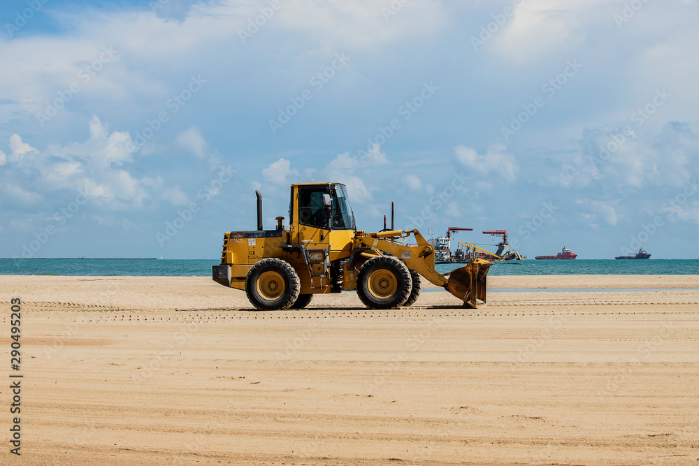 Tractor is working on the beach.