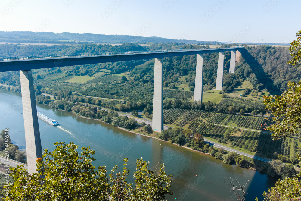 View on high freeway viaduct bridge across Mosel river valley and terraced vineyards, road network and transportation is Germany
