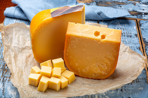 Obraz na płótnie Aged and young Dutch Gouda cheese and cheese cubes blocks, tasty european food