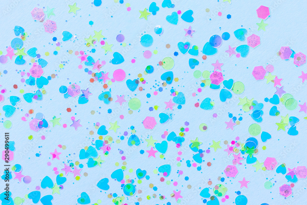 Festive pastel blue background. Bright colorful decor elements hearts, stars, circles. Flat lay style. Space for text.