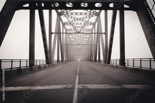 Bridge through Zeya river in a heavy fog photo