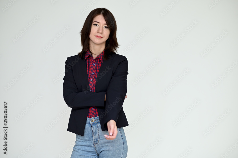 Portrait of a pretty asian brunette girl with black hair in a dark jacket and blue jeans on a white background. It stands right in front of the camera, with emotions in various poses. Portrait of a pretty asian brunette girl with black hair in a dark jacket and blue jeans on a white background. It stands right in front of the camera, with emotions in various poses.