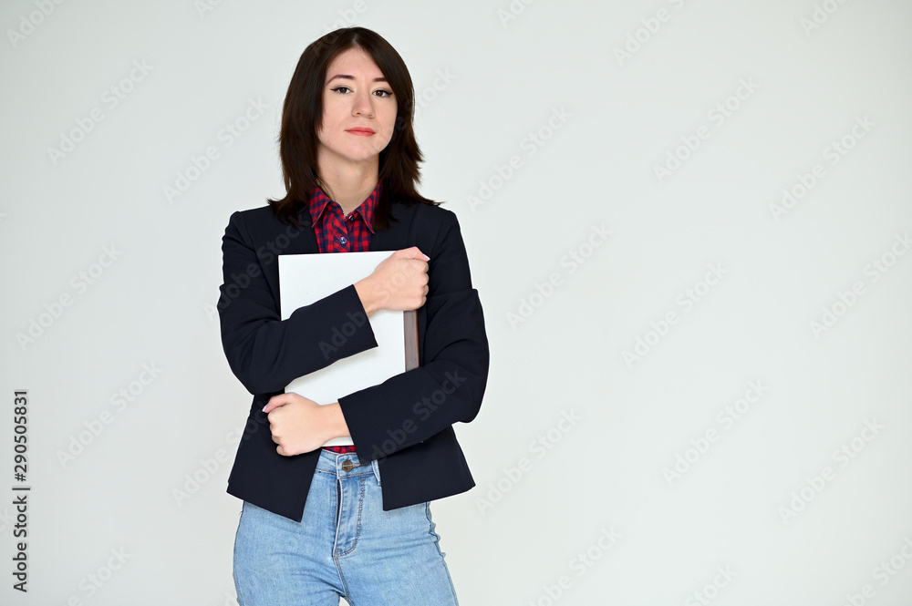 Portrait of a pretty asian brunette girl with black hair in a dark jacket and blue jeans on a white background. It stands right in front of the camera, with emotions in various poses. Portrait of a pretty asian brunette girl with black hair in a dark jacket and blue jeans on a white background. It stands right in front of the camera, with emotions in various poses.