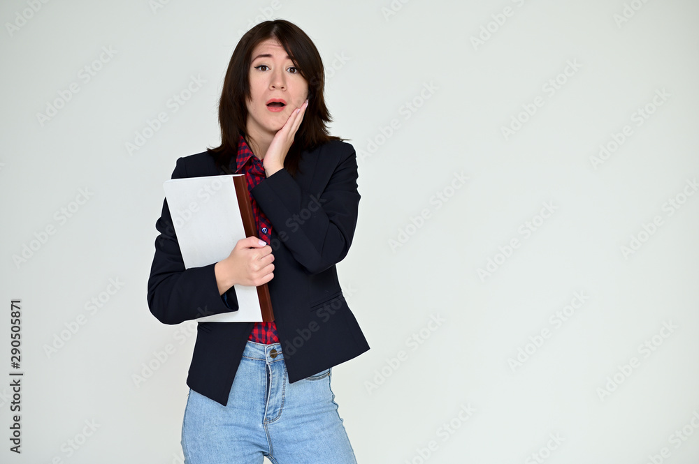 Portrait of a pretty asian brunette girl with black hair in a dark jacket and blue jeans on a white background. It stands right in front of the camera, with emotions in various poses. Portrait of a pretty asian brunette girl with black hair in a dark jacket and blue jeans on a white background. It stands right in front of the camera, with emotions in various poses.