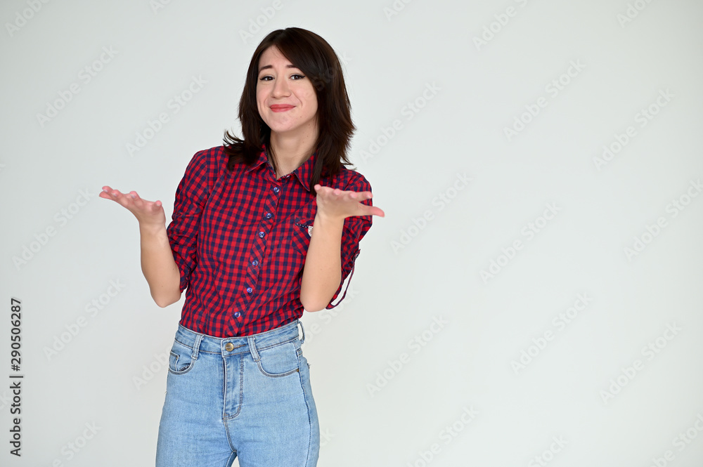 Portrait of a pretty asian brunette girl with black hair in a burgundy shirt and blue jeans on a white background. It stands right in front of the camera, with emotions in various poses. Portrait of a pretty asian brunette girl with black hair in a burgundy shirt and blue jeans on a white background. It stands right in front of the camera, with emotions in various poses.