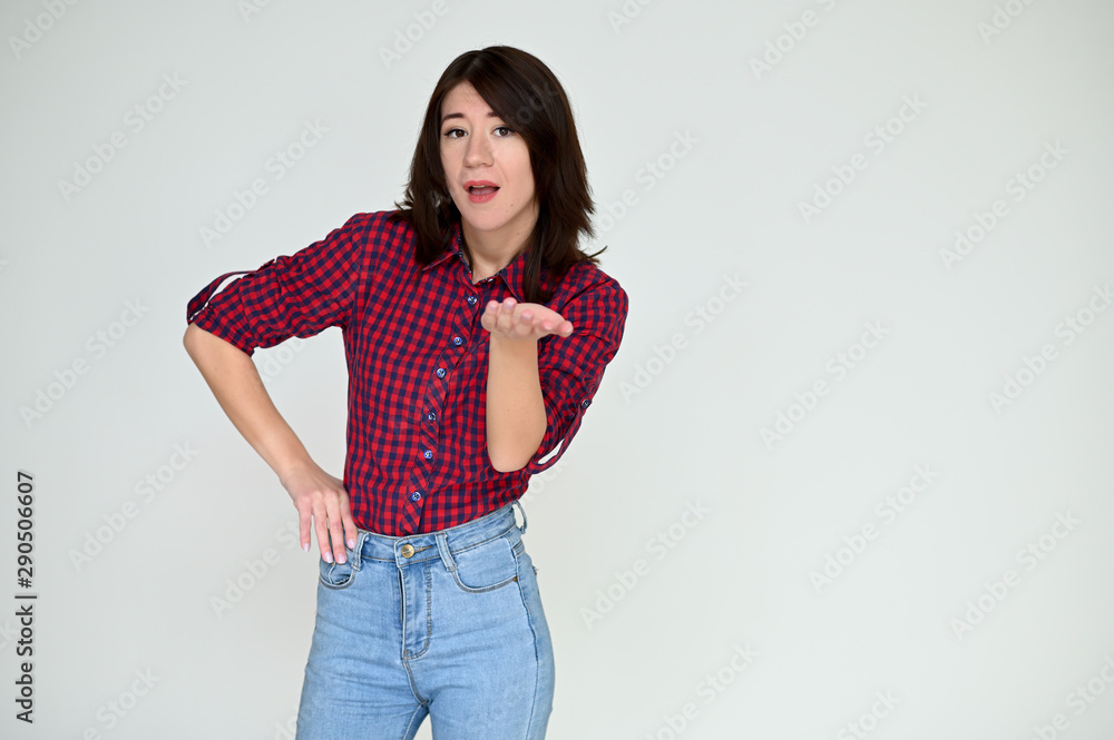 Portrait of a pretty asian brunette girl with black hair in a burgundy shirt and blue jeans on a white background. It stands right in front of the camera, with emotions in various poses. Portrait of a pretty asian brunette girl with black hair in a burgundy shirt and blue jeans on a white background. It stands right in front of the camera, with emotions in various poses.