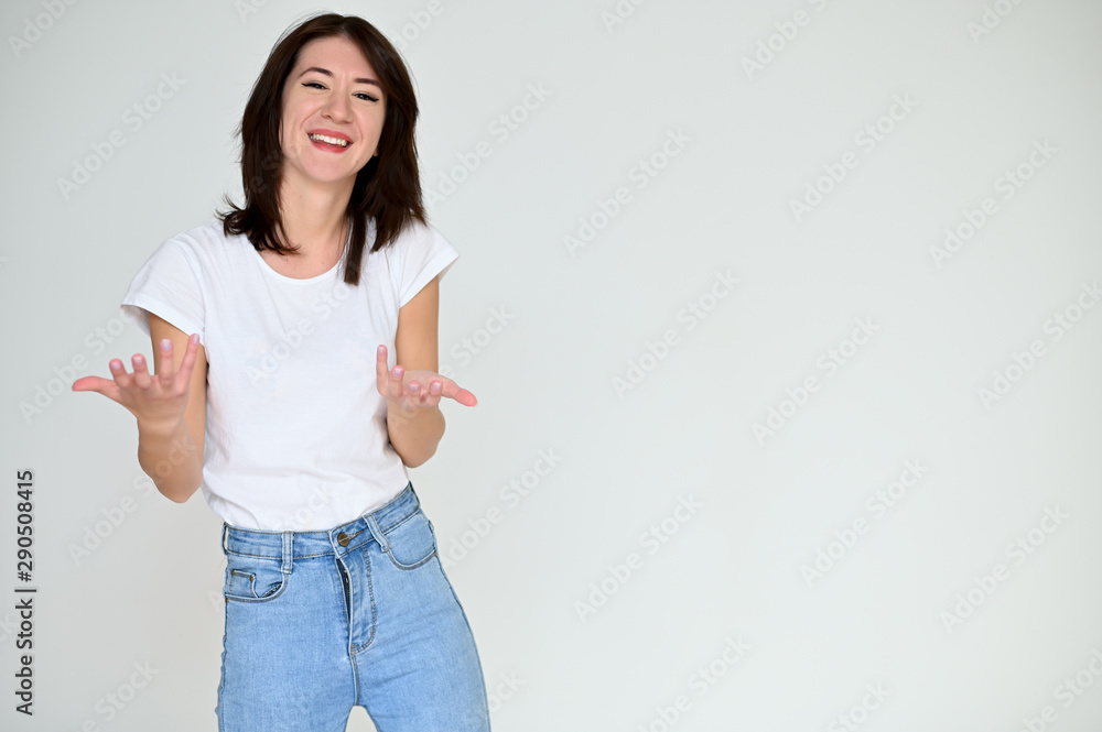 Portrait of a pretty asian brunette girl with black hair in a white t-shirt and blue jeans on a white background. It stands right in front of the camera, with emotions in various poses. Portrait of a pretty asian brunette girl with black hair in a white t-shirt and blue jeans on a white background. It stands right in front of the camera, with emotions in various poses.