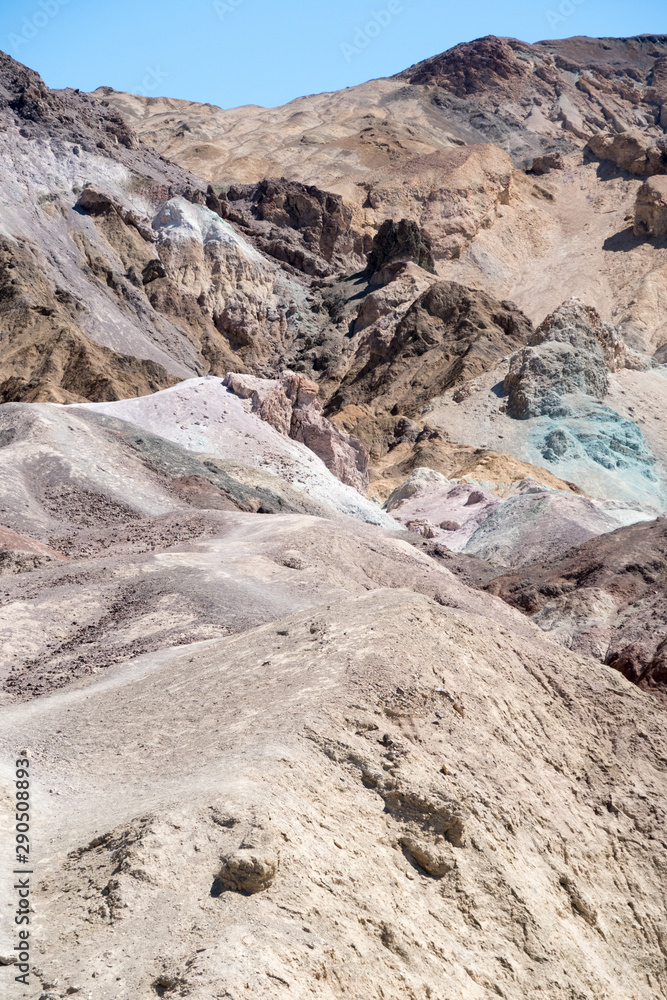 View of a vast Death Valley landscape, empty roads , rock formations and the badwater basin salt deposits. View of a vast Death Valley landscape, empty roads , rock formations and the badwater basin salt deposits.
