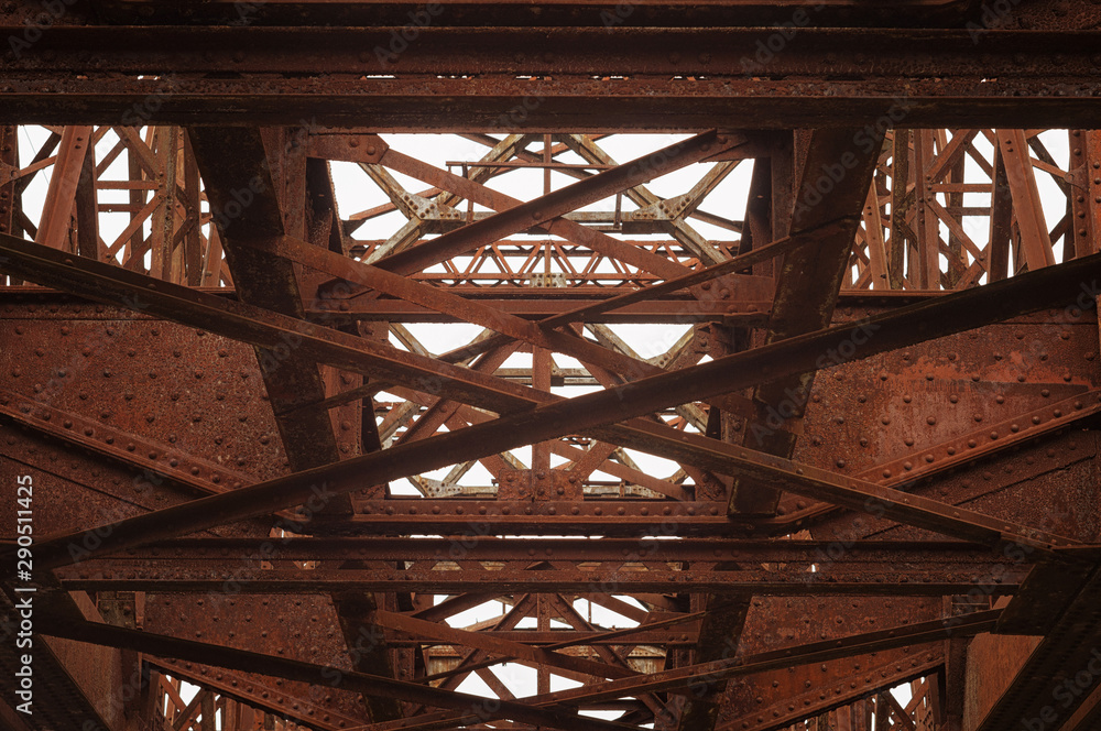 Old iron rusted reinforcement armature structure of a railway bridge with rivets Old iron rusted reinforcement armature structure of a railway bridge with rivets