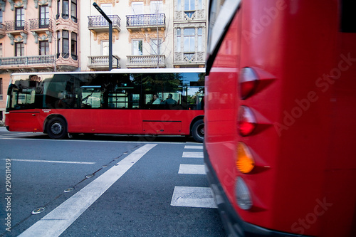 Crossing of urban buses in opposite directions from Gran via, Granada, Spain