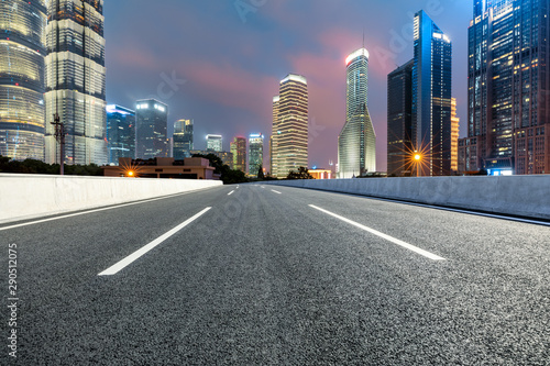 Shanghai modern commercial buildings and asphalt highway at night,China.