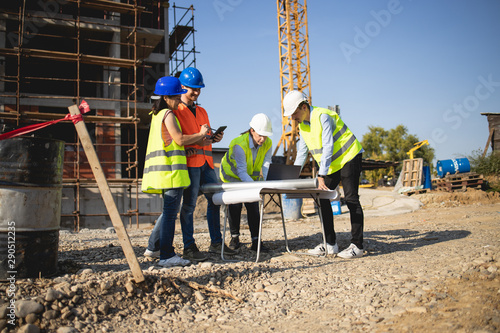 Four construction workers having meeting,stock photo