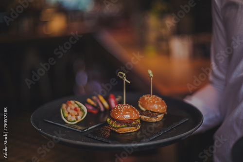 A close up shot of a selection of canape dishes. Concept of catering, hospitality and lifestyle. Small snacks and nibbles served on black slates for a private reception.
