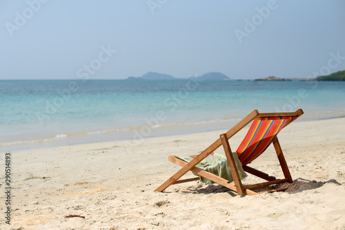 Chaise lounge on the tropical beach at sunny summer day. Travel vacation relax concept. Free copy space.