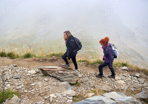 Backpacker ladies hiking on a trail