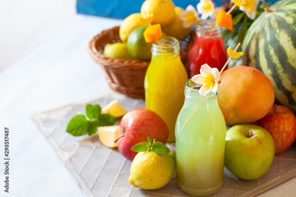 Fresh fruit, berry and vegetable juices on bright blue background.Homemade refreshing beverage Fresh fruit, berry and vegetable juices on bright blue background.Homemade refreshing beverage