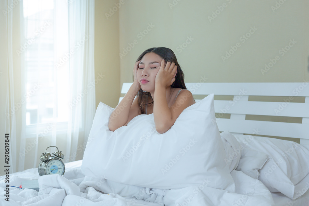 A beautiful young woman is sleeping and an alarm clock in the bedroom at home. A beautiful young woman is sleeping and an alarm clock in the bedroom at home.