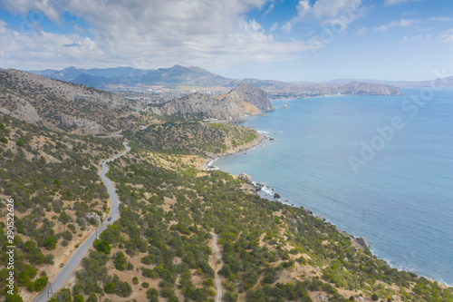 Aerial view of serpentine road in green mountains and sea, Black Sea, Novyi Svit, Crimea