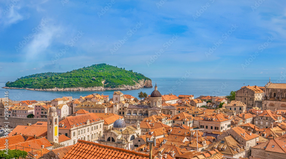 High angle view of the Old Town in Dubrovnik, with green Lokrum Island in the Adriatic Sea.