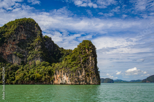 Thailand. Near Phuket. Cliffs of the Andaman Sea. Traveling in Thailand. Holidays in Thailand. Rocky coast in the middle of the sea. Walk on the ocean. Middle East Asia. Green cliff.