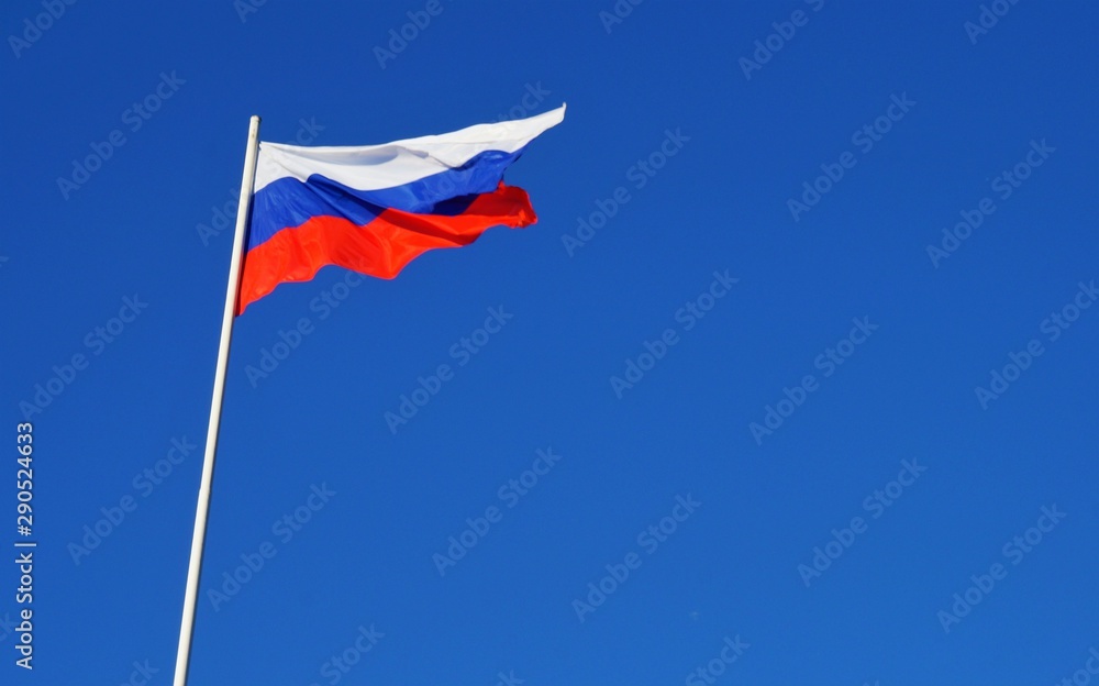 Russian Federation flag against blue sky, copy space