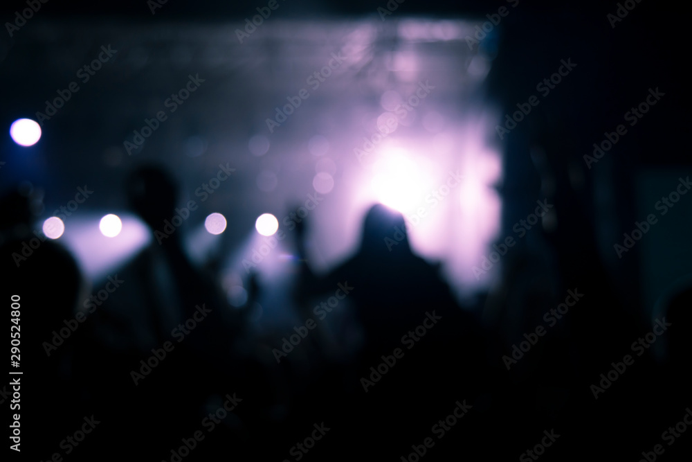 night club festival music party abstract picture with people unfocused silhouette shape on stage spot light illumination background 