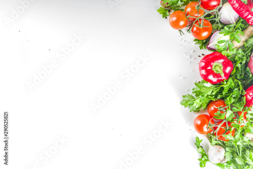 Cooking background with fresh vegetables and herbs. Healthy clean eating vegetarian food, diet nutrition concept. Various fresh veggie ingredients for salad or stew, white table, top view copy space