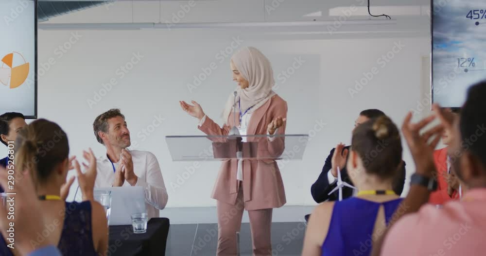 Female speaker and applauding audience at a business conference Female speaker and applauding audience at a business conference
