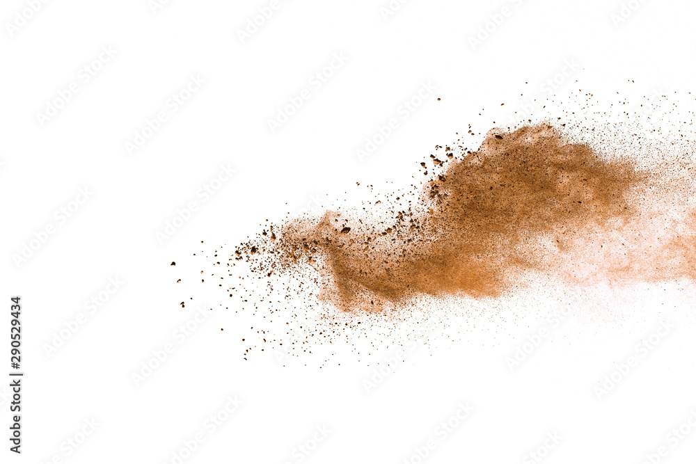 Abstract brown powder explosion. Closeup of brown dust particle splash isolated on white background Abstract brown powder explosion. Closeup of brown dust particle splash isolated on white background