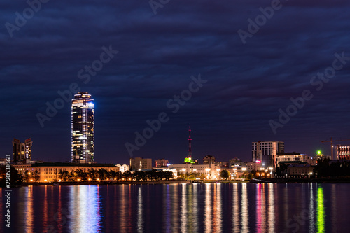 View of Yekaterinburg city pond with night city lights and skyscraper