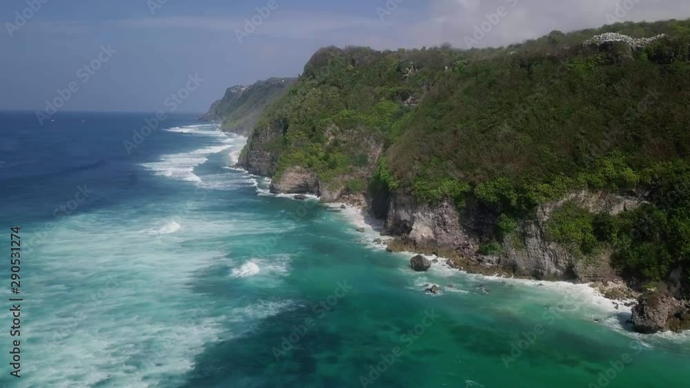 Flying over long sea waves breaking on high mountains at sunny day. Flying over long sea waves breaking on high mountains at sunny day.