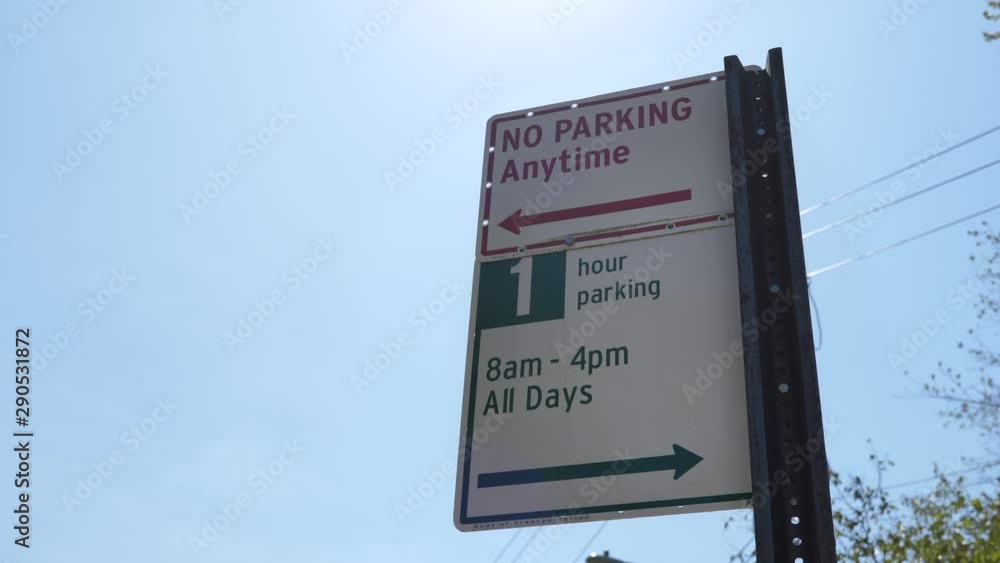No parking anytime sign outside with 1 hour parking No parking anytime sign outside with 1 hour parking
