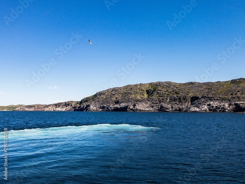 Contrast beautiful scene with green island between bay of sea and blue sky