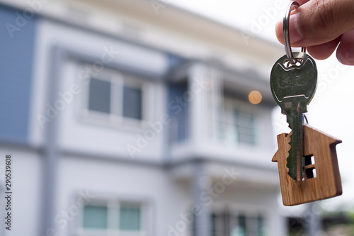 Landlord unlocks the house key for new home. Real Estate Agents, Sales Agents Home for sale and for rent