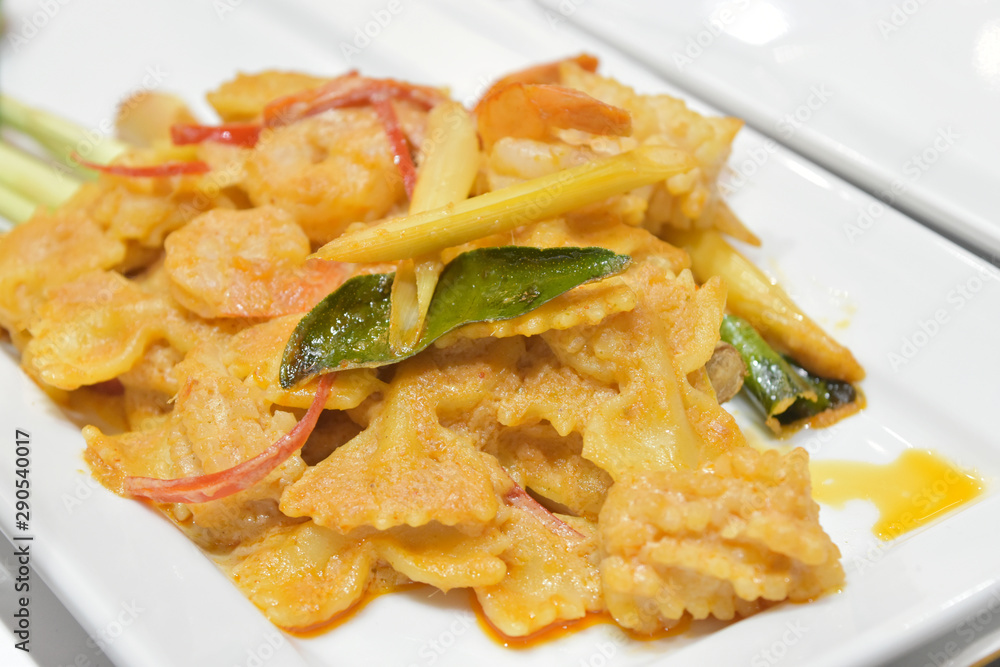 Curry fried shrimp or prawn with coconut milk and Kaffir lime leaf, lemongrass leaf, carrot slice, thailand food. Curry fried shrimp or prawn with coconut milk and Kaffir lime leaf, lemongrass leaf, carrot slice, thailand food.