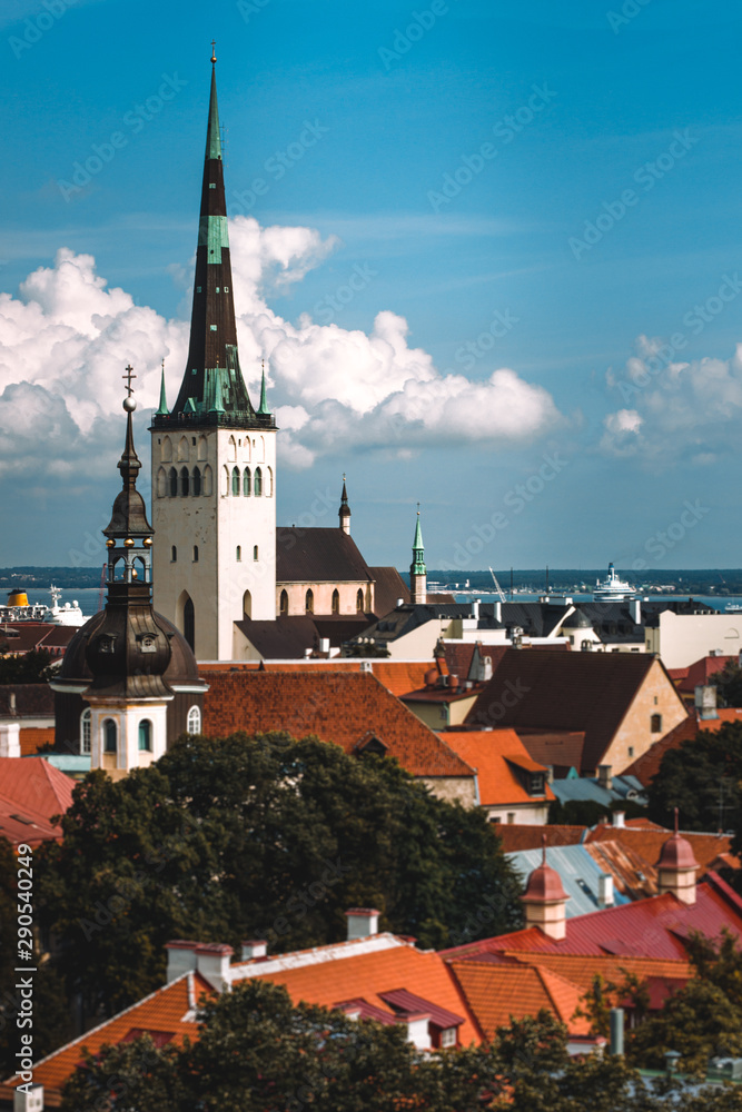 Scenic summer aerial panorama of the Old Town architecture in Tallinn, Estonia. View with traditional red tile roofs, medieval churches and walls