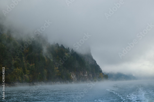 Foggy landscape in autumn on a lake in Norway in the mountains.