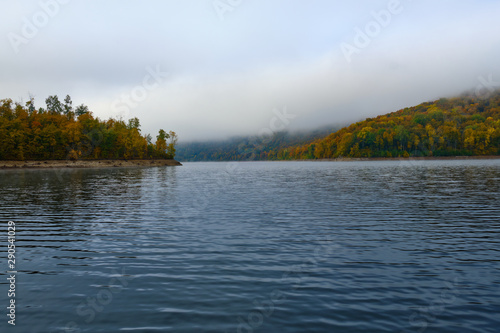 Foggy landscape in autumn on a lake in Norway in the mountains.