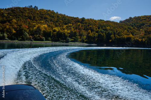 Wake from the boat on autumn lake in Sweden. Trace from a boat on the water