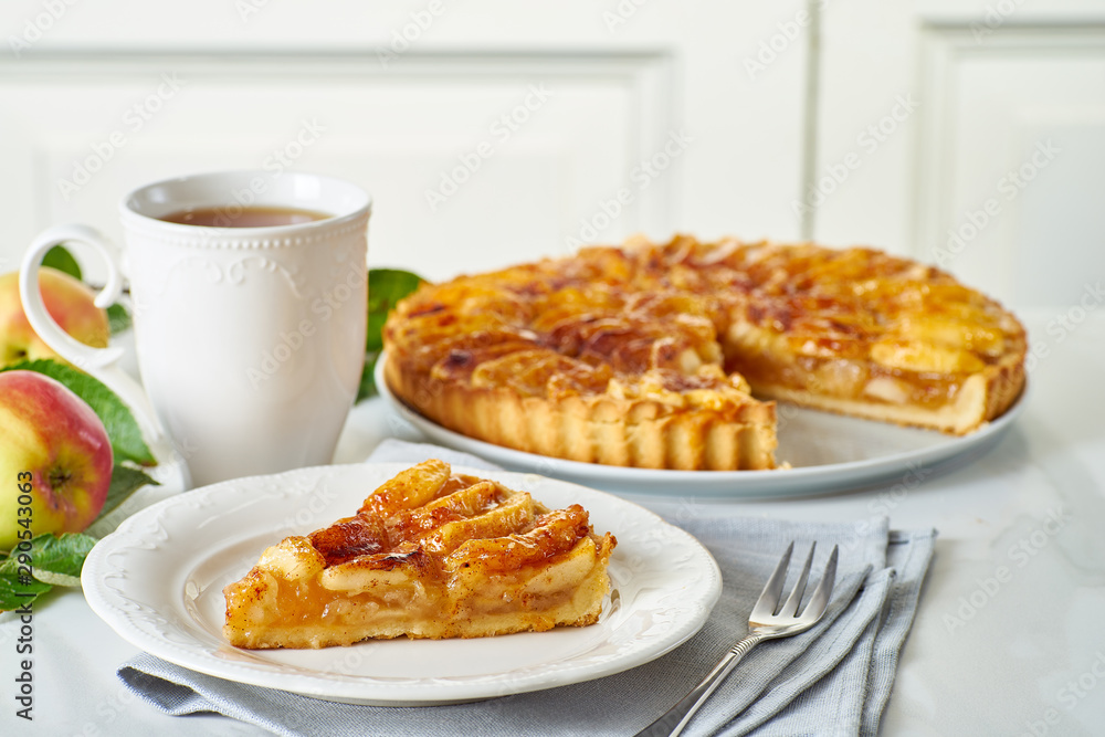 Breakfast with traditional french apple tart piece