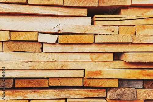 Sawn and folded boards, construction boards, full-screen lumber as a background