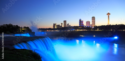 Niagara Falls at dusk including the skyline of the Canadian city of the background
