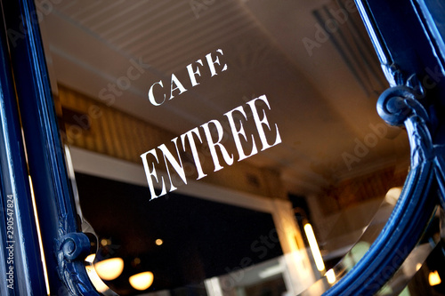 Photography Signs on the window of a vintage French cafe