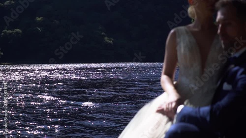 Bride and Groom During the Weeding Day Outdoor in the Middle of the Nature Beside the Lake Slow Motion photo